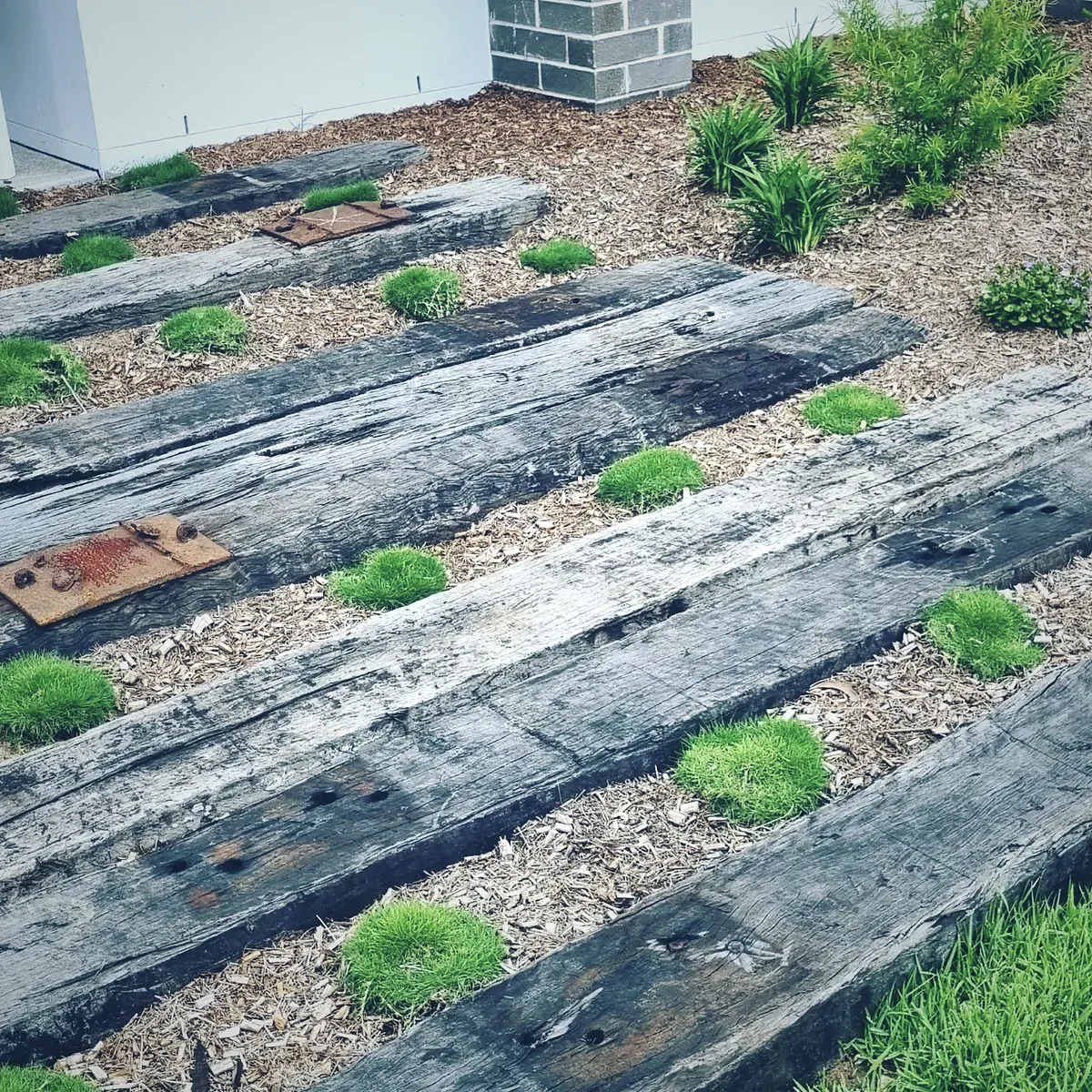 Recycled hardwood sleeper path bedded into mondo grass and mulch